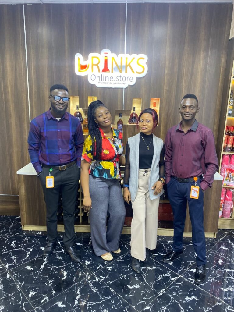 Drinks Online Store staff posing at the store's entrance